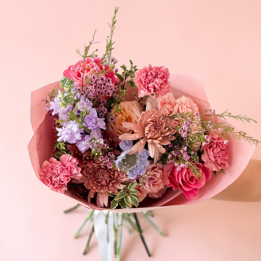 Bouquet of flowers with pink and purple spring flowers wrapped in premium korean paper for First Mother's Day gift for pickup or Delivery. The Petal Edina. Minneapolis