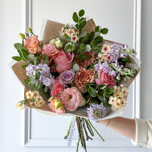 Bouquet of luxury flowers including lisianthus, roses, and phlox hand-tied in our signature wrap for pickup or delivery in Minneapolis, Edina, Plymouth, and Minnetonka.