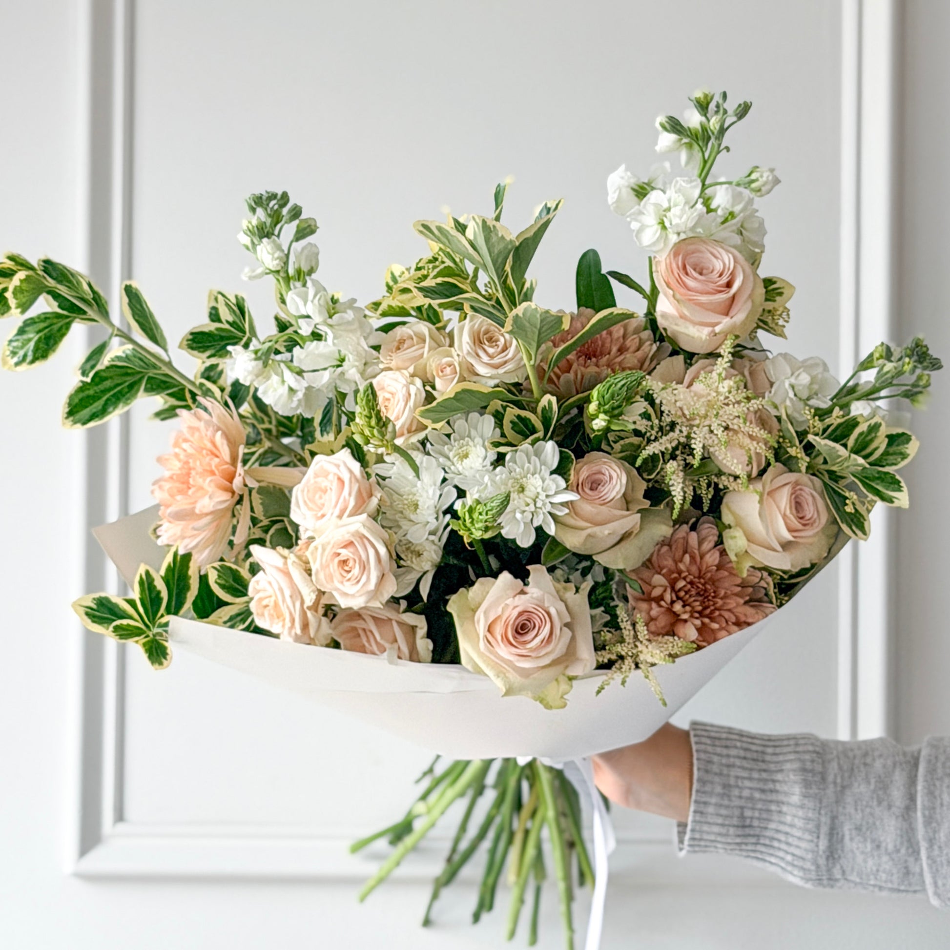 Bouquet of white, blush pink and peach flowers artfully designed for the perfect gift. Order from your trusted, flower shop, The Petal for pickup or delivery in Minneapolis, Edina, Bloomington, or Wayzata.