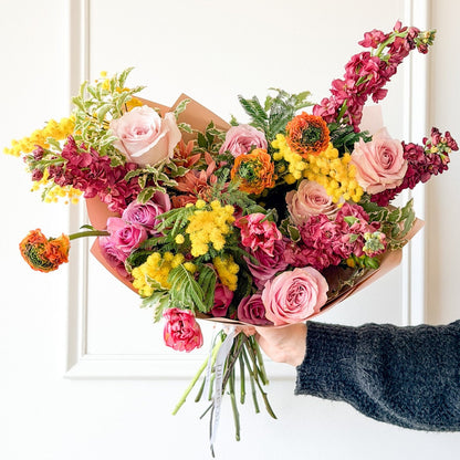 Signature hand-tied March bouquet featuring yellow Mimosa accents, perfect for you or the flower lover in your life. Order online today!