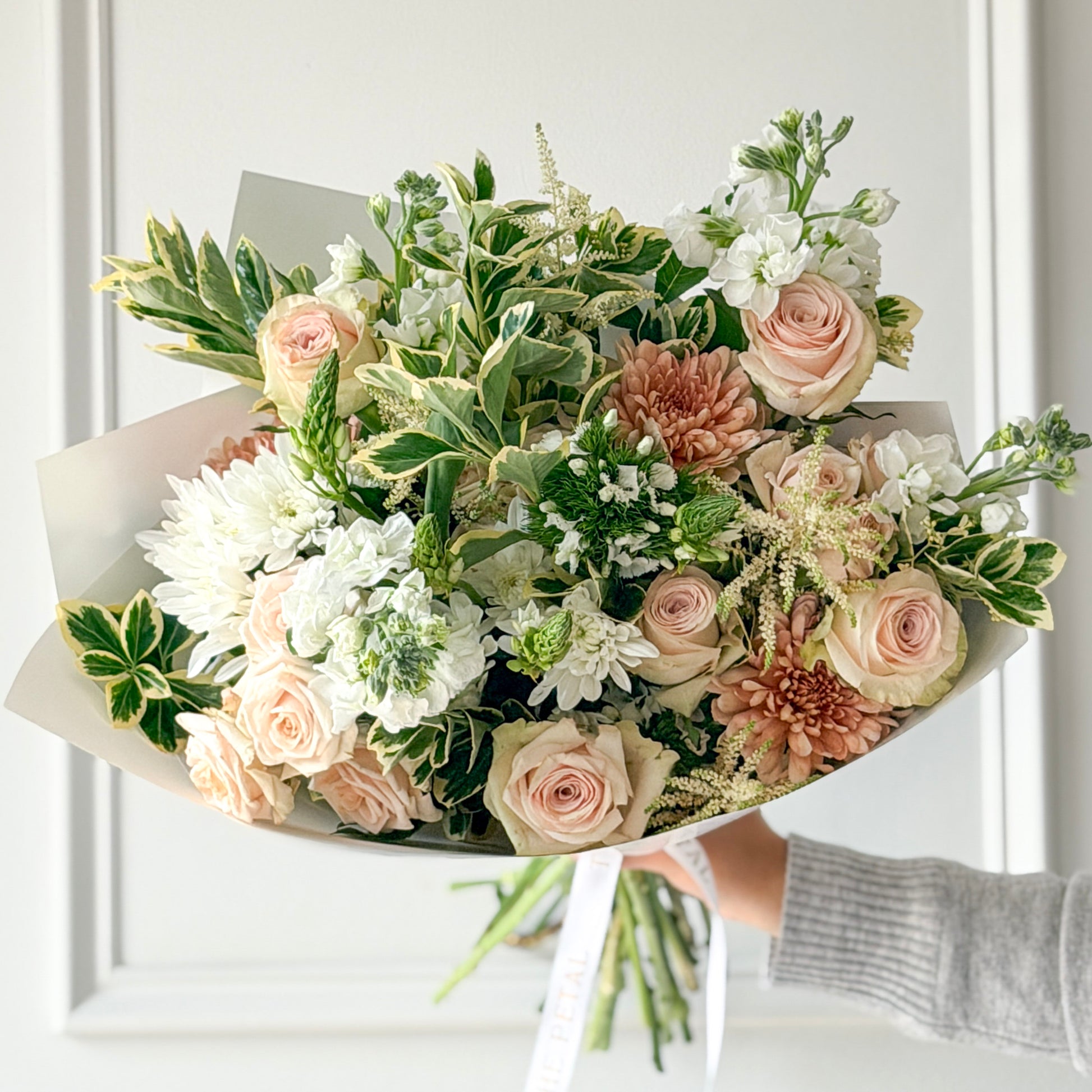 Gorgeous bouquet of soft neutrals, whites, peaches, and blush pink flowers and soft greenery from a luxury local flower shop in Edina.  Order for pickup or delivery in Minneapolis area.
