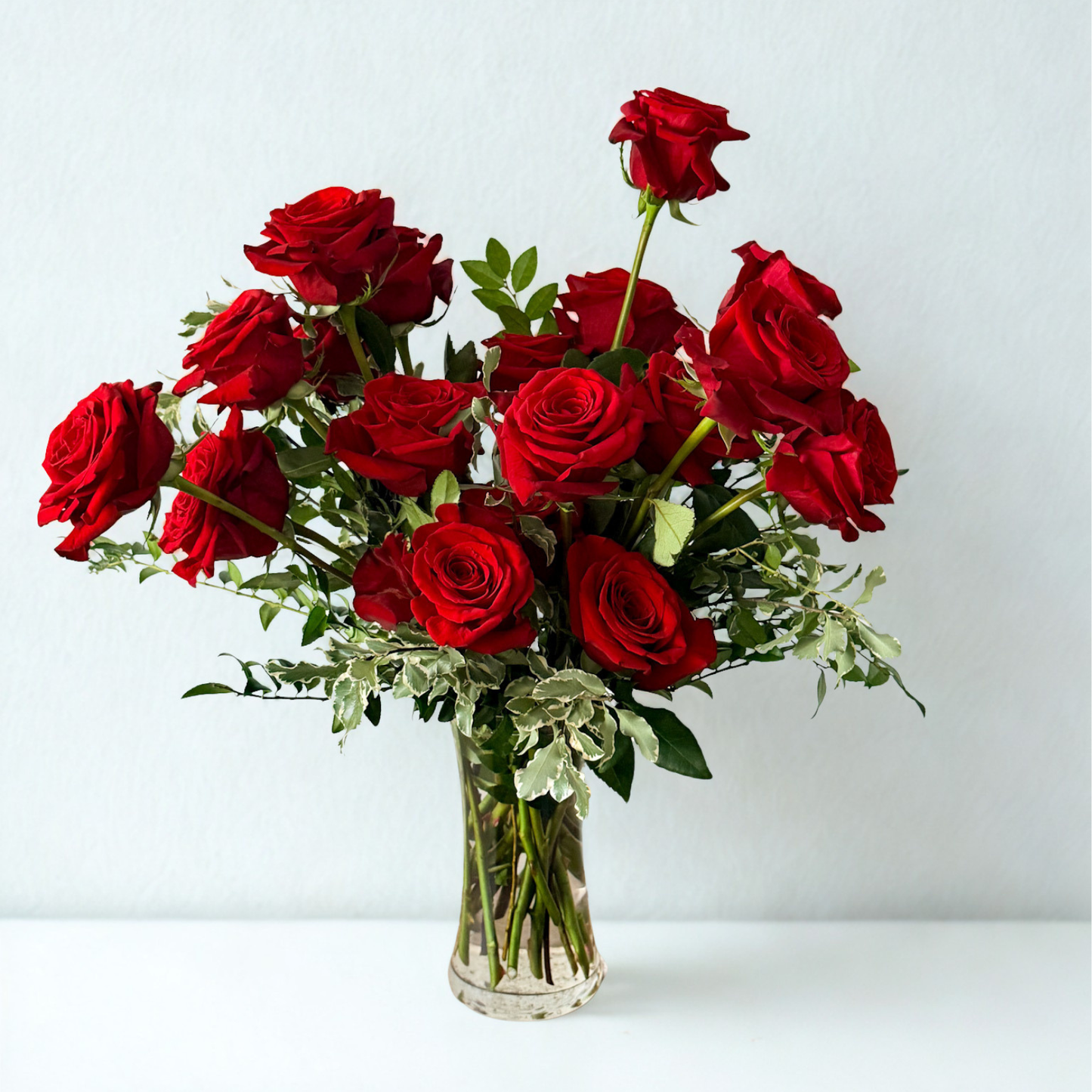 Luxury premium red roses in a glass vase arrangement. Classic, romantic. 
