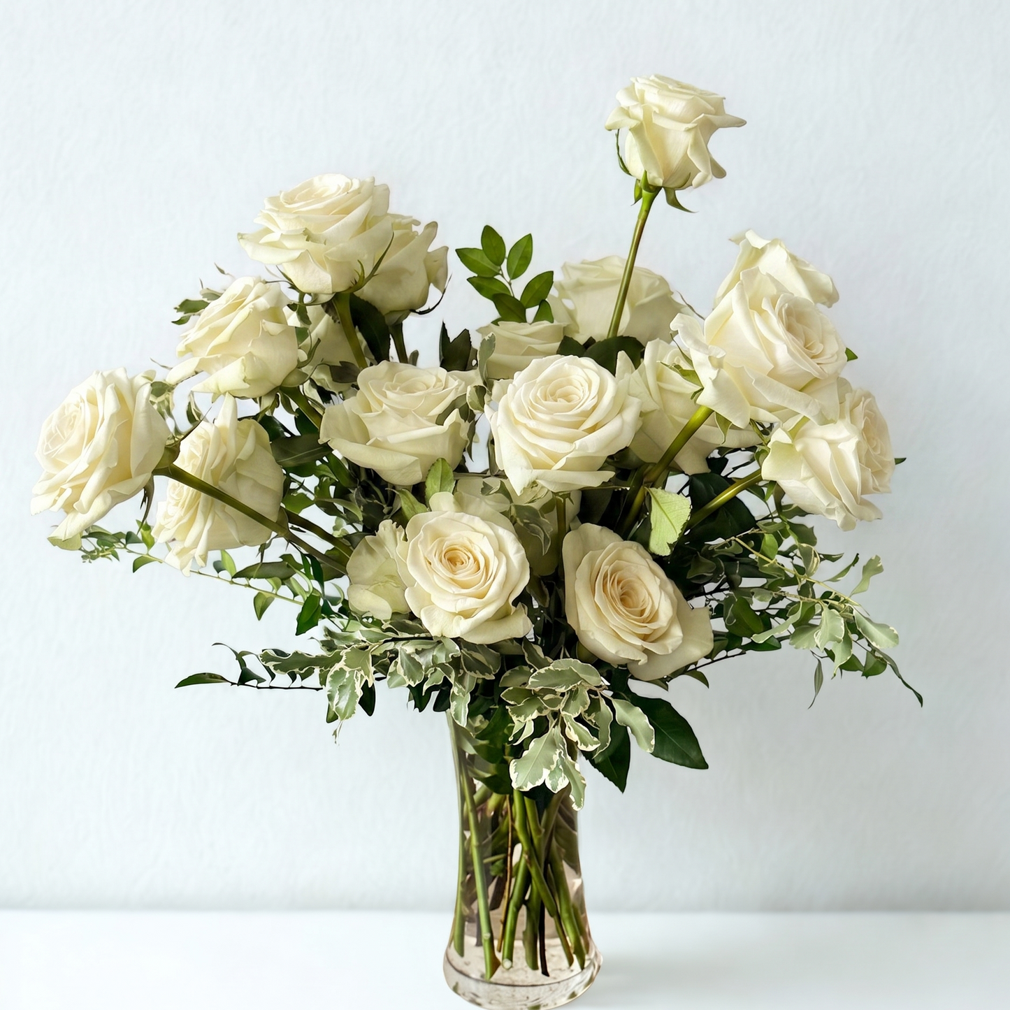 romantic white roses in a glass vase for your anniversary, birthday, sympathy or get well. delivery in minnesota