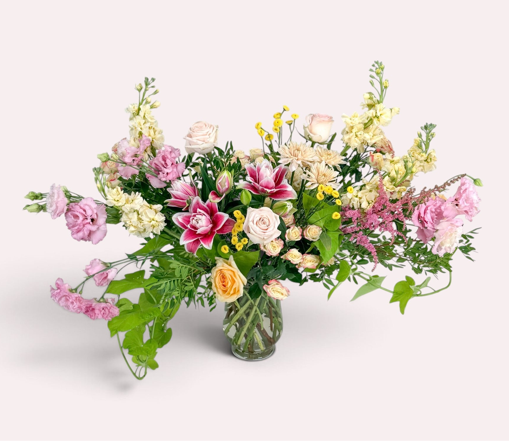Luxury seasonal flower arrangement in pinks and yellows, delivered locally to Edina, Minneapolis, and surrounding areas.
