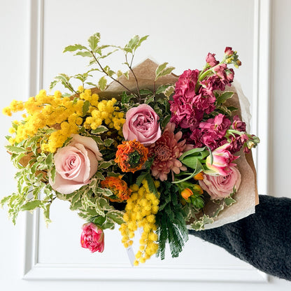 Add a gorgeous pop of color to your home this month! Mixed florals with greenery wrapped in Kraft paper, ready for pick-up or delivery.