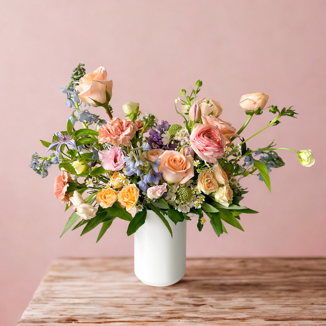 Garden-inspired Signature floral arrangement with light, colorful seasonal blooms in ceramic vase, luxury arrangement for Minneapolis delivery