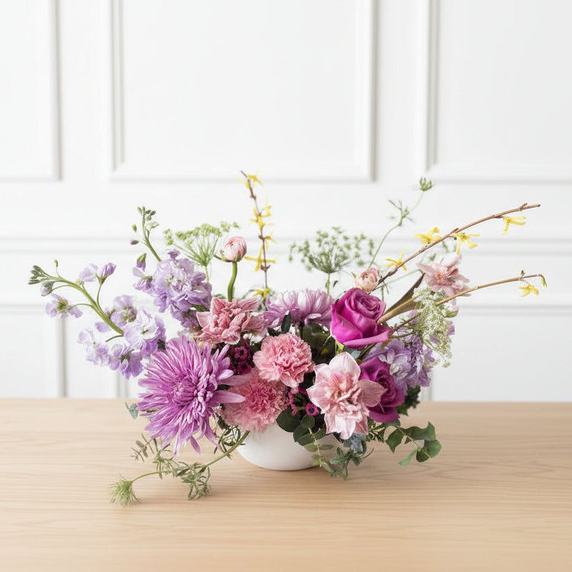 soft pastel garden centerpiece for easter filled with spring flowers.