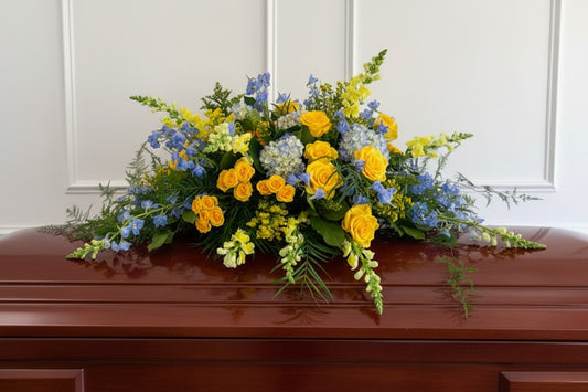 Luxury Classic casket spray featuring colorful seasonal blooms, elegant arrangement available for pick-up in Edina or delivery to Richfield, Hopkins, and Golden Valley