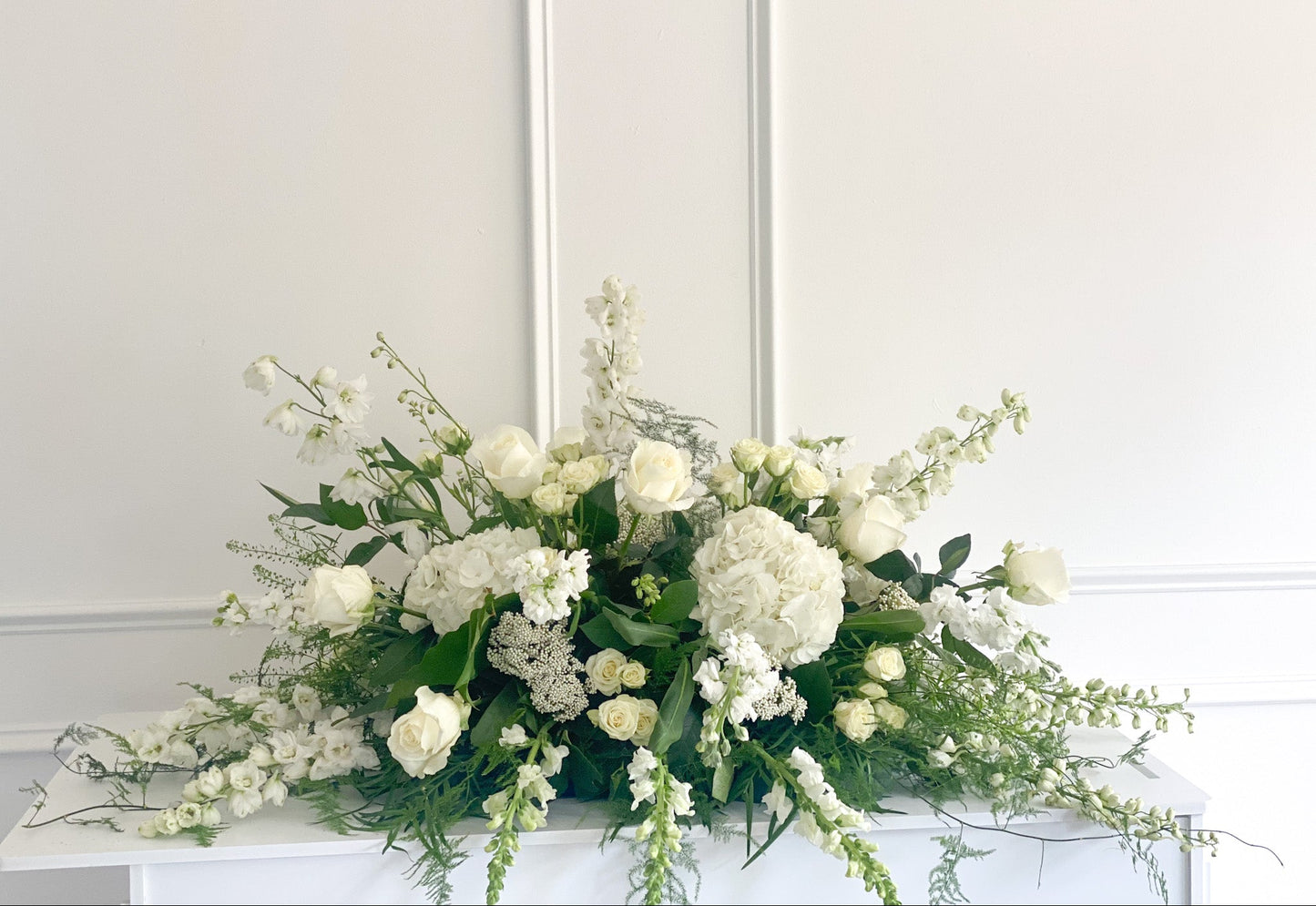 Luxury Premium casket spray with elevated white & green blooms, elegant garden-inspired design, pick-up or delivery available to Uptown Minneapolis, South Minneapolis, and Richfield