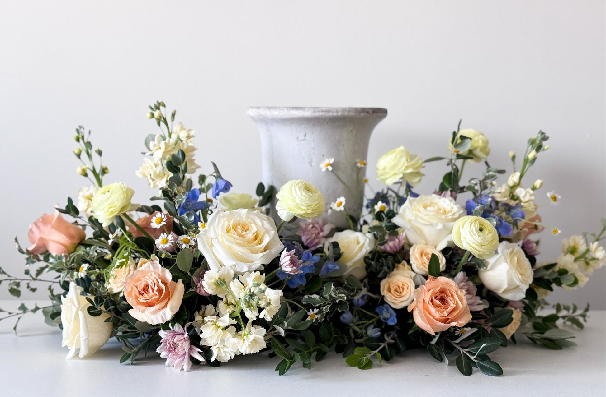 Luxury Classic urn surround with natural seasonal blooms, elegant funeral flowers arrangement, pick-up in Edina or delivery to Richfield, Hopkins, and Golden Valley