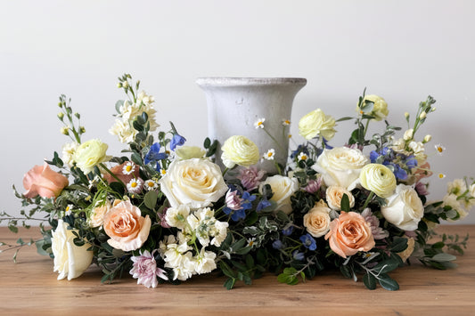 Luxury Classic urn surround with natural seasonal blooms, elegant funeral flowers arrangement, pick-up in Edina or delivery to Richfield, Hopkins, and Golden Valley. Cremation society