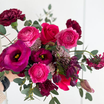 Vibrant and colorful bridal bouquet with bright seasonal flowers in an organic garden style for a small wedding in Minneapolis.