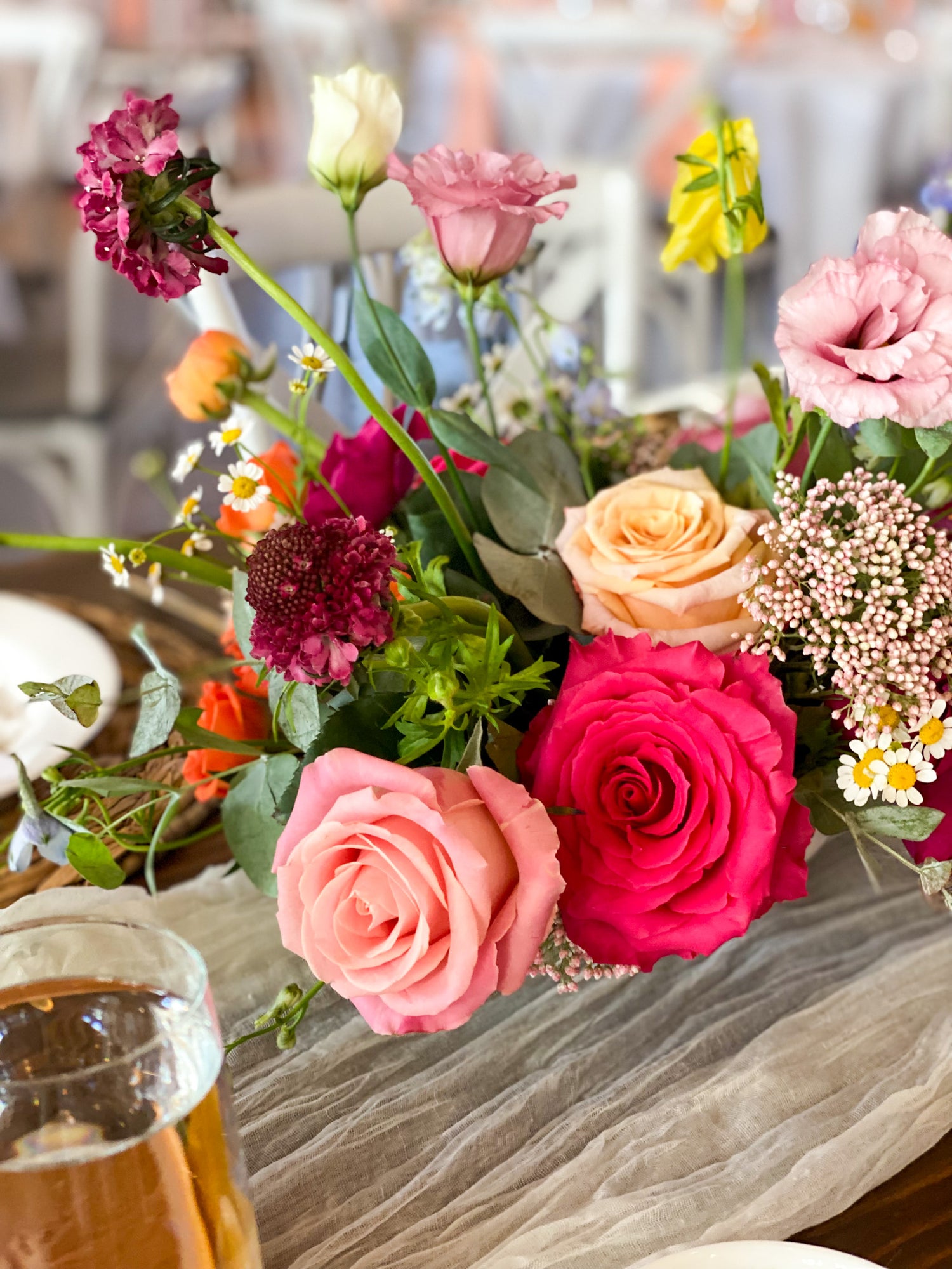 colorful summer centerpiece for a luxury garden style wedding filled with lisianthus, scabiosa, roses, rice flower, and ranunculus. Machine Shop