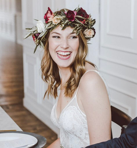 A bride wearing a full floral flower crown for her wedding also great for music festivals and parties. Order now for pickup in Edina from The Petal.