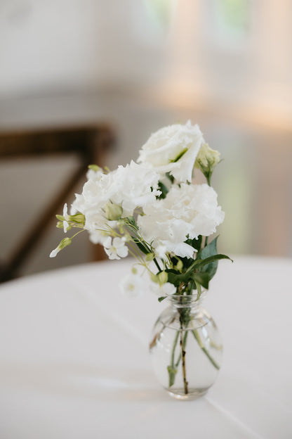glass bud vase with white flowers for special event.