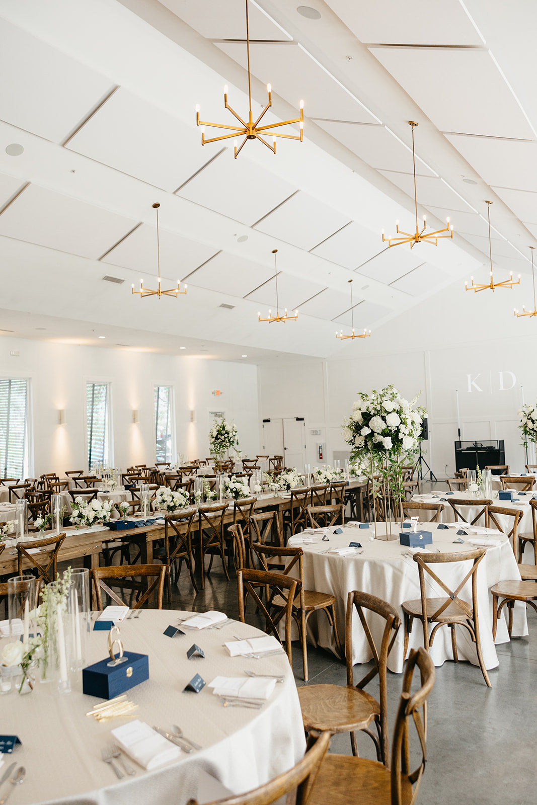 Elegant wedding reception setup with tables, chairs, and floral arrangements at Hutton House.