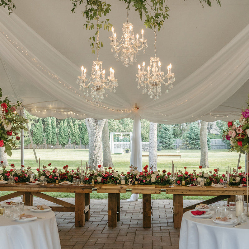 luxury outdoor tented wedding with romantic chandeliers and greenery at Gardens of Castle Rock Minnesota