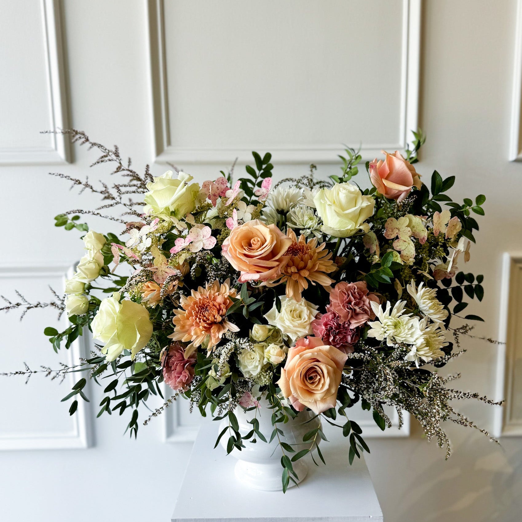 Deluxe sympathy arrangement with natural seasonal blooms in ceramic vase, luxury garden-style floral design delivered to Downtown Minneapolis, Linden Hills, and Kingfield