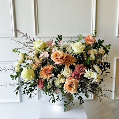 Deluxe sympathy arrangement with natural seasonal blooms in ceramic vase, luxury garden-style floral design delivered to Downtown Minneapolis, Linden Hills, and Kingfield
