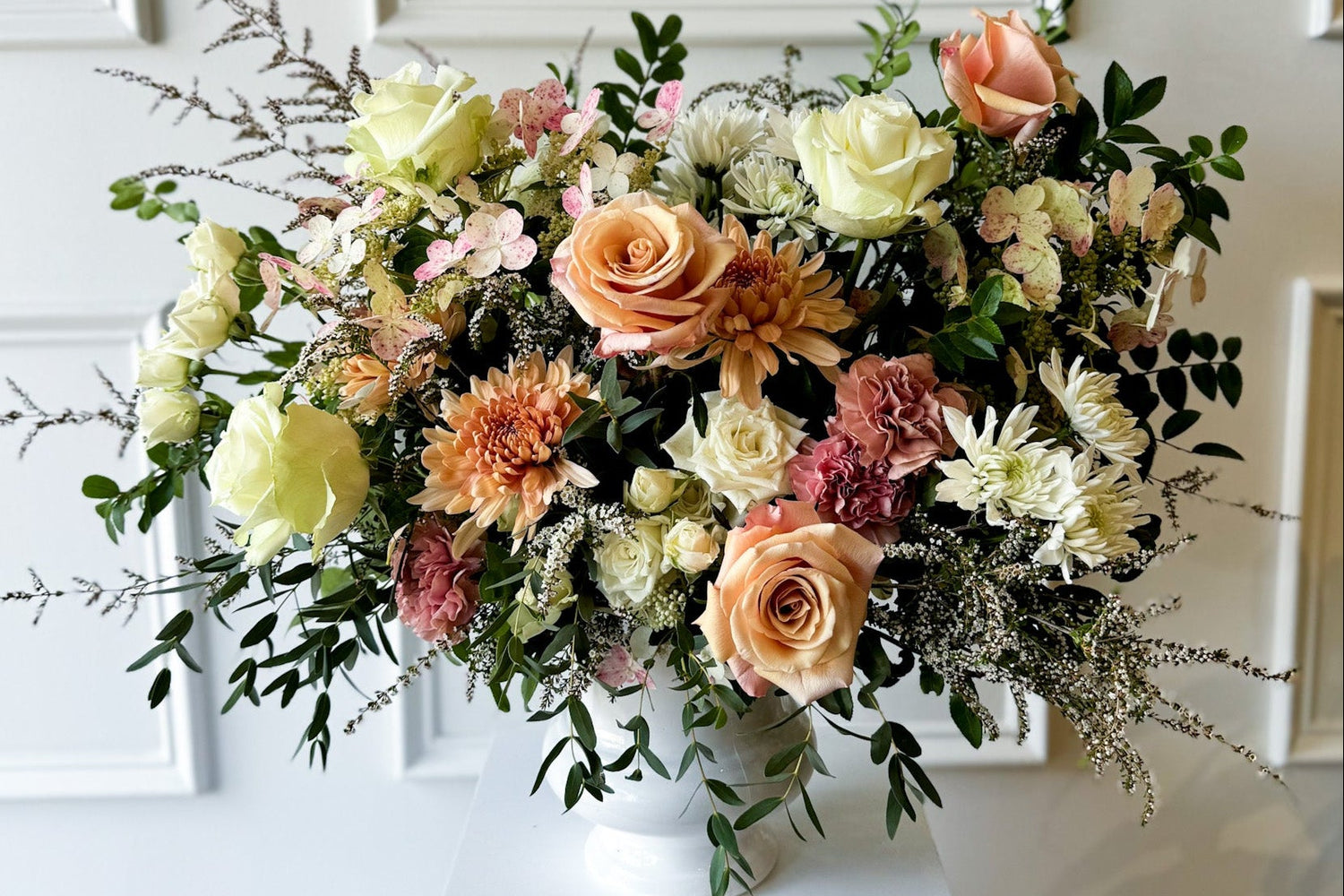 Deluxe sympathy arrangement with natural seasonal blooms in ceramic vase, luxury garden-style floral design delivered to Downtown Minneapolis, Linden Hills, and Kingfield