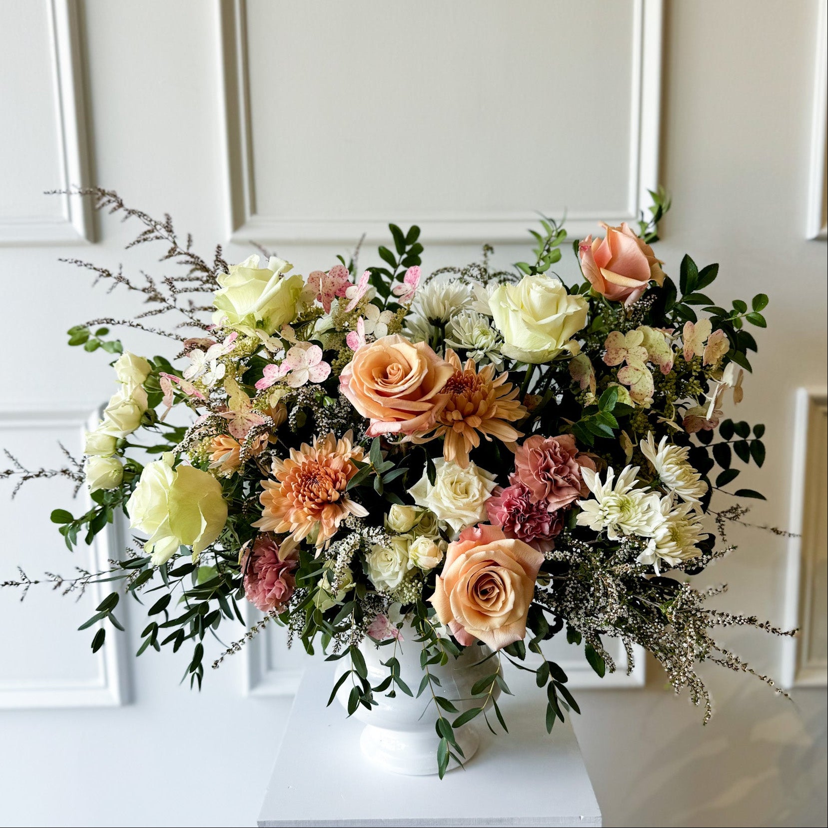 Deluxe sympathy arrangement with natural seasonal blooms in ceramic vase, luxury garden-style floral design delivered to Downtown Minneapolis, Linden Hills, and Kingfield