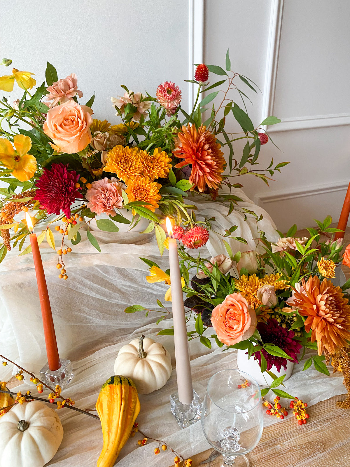 Classic garden-style Thanksgiving floral arrangement featuring delicate fall blooms and textured greenery, perfect centerpiece or gift