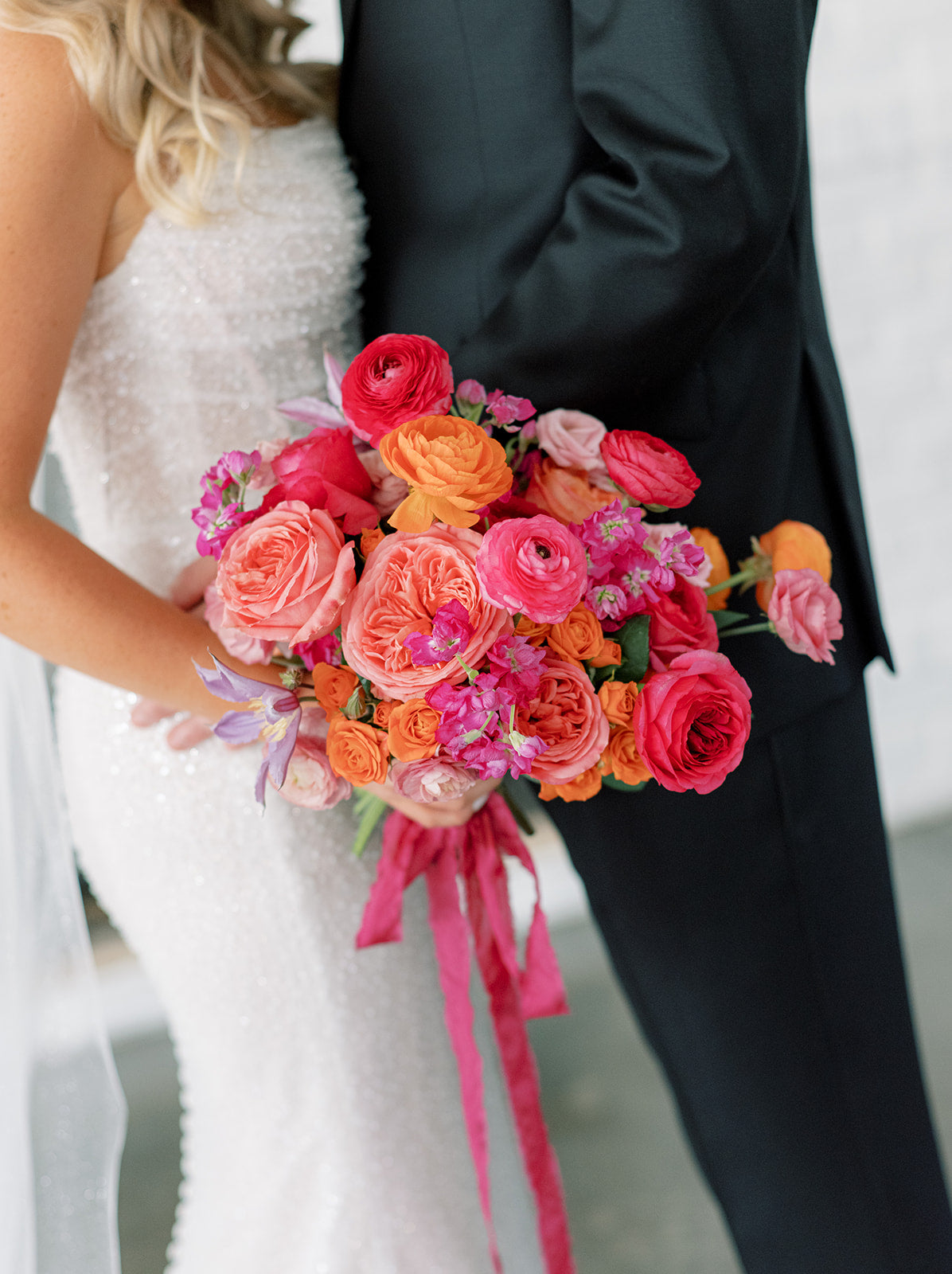 Colorful summer bridal bouquet filled with garden roses and ranunculus for a wedding in edina.