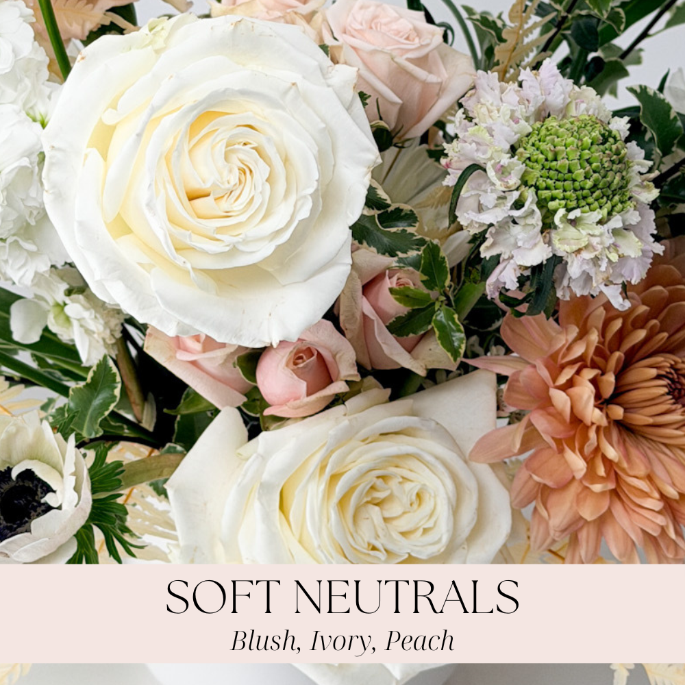A floral arrangement of ivory, white, blush pink, and peach flowers for all occasions for delivery in Minneapolis, Bloomington, and Richfield.