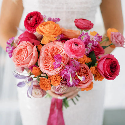 Colorful summer bridal bouquet in tasteful pinks, oranges, and fuchia for a luxury wedding at the Hutton House by top florist The Petal.
