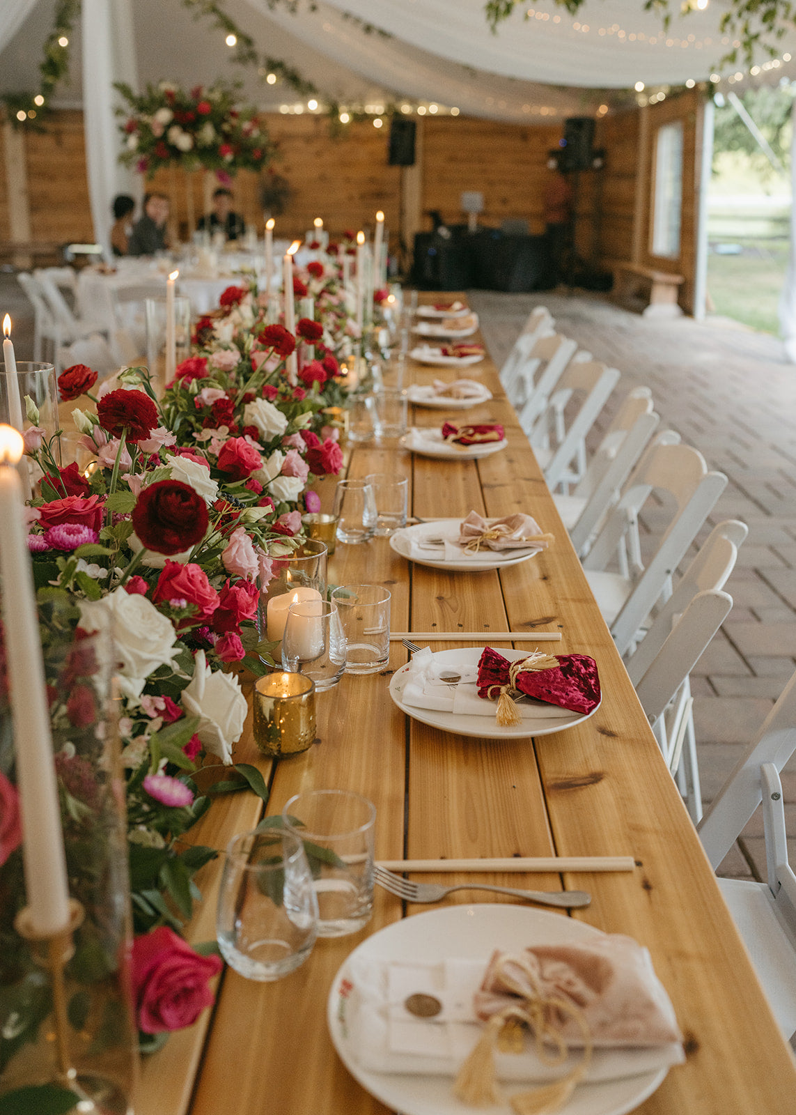 bespoke colorful floral runner for head table accented with romantic taper candles at southeast asian wedding in Minneapolis.