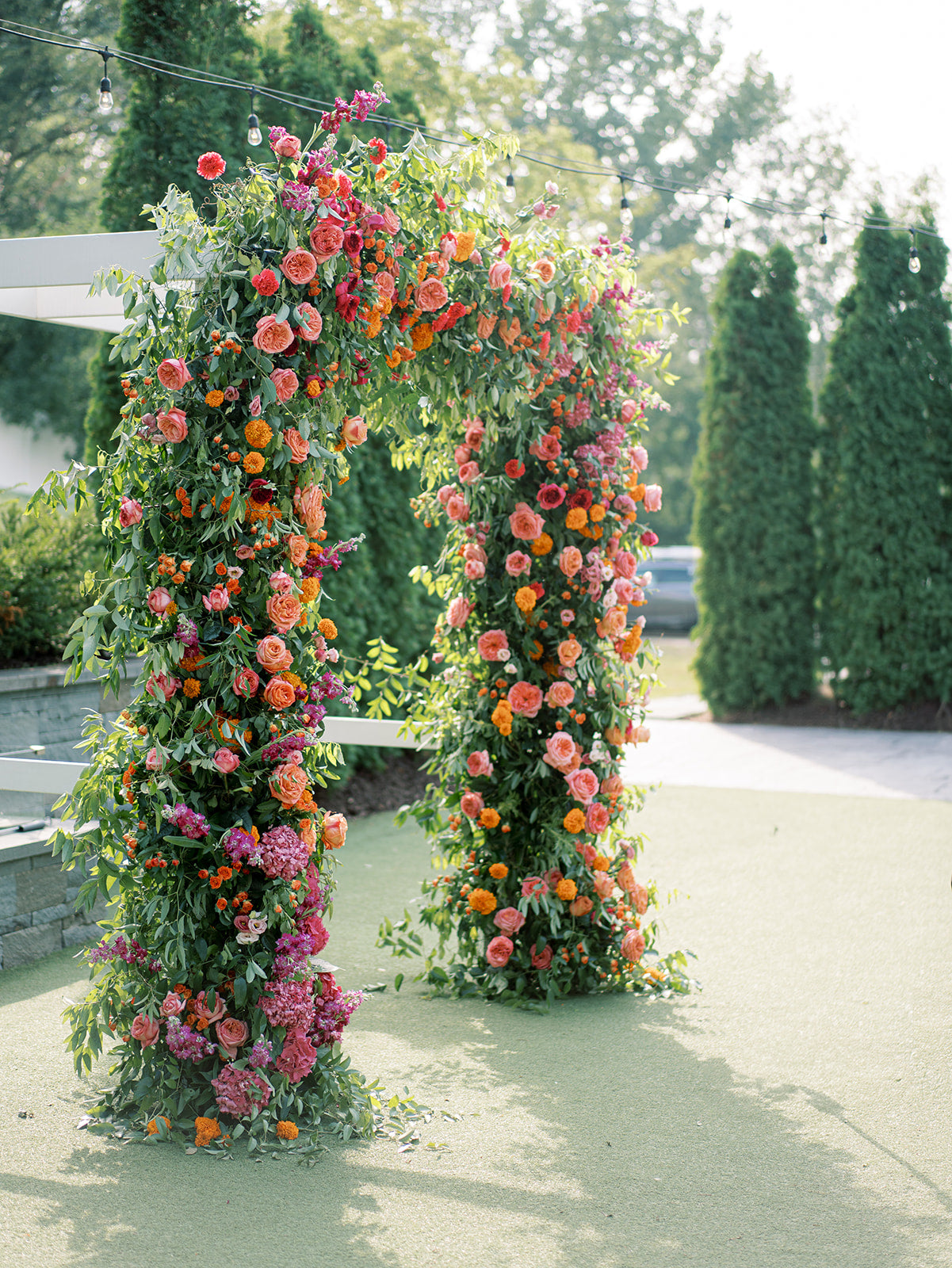 Colorful lush floral arch for a luxury Minneapolis wedding at the Hutton House. Amanda Nippoldt photography. Pink Peony wedding planners