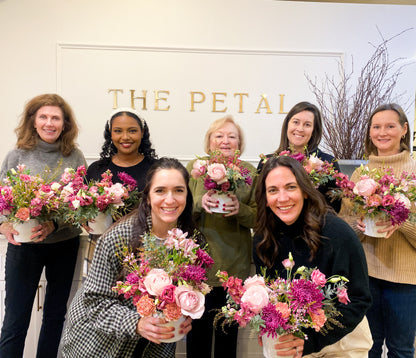 A group of ladies at a floral workshop at The Petal in Minneapolis with their flowers. 