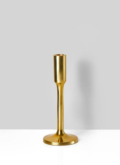 A modern gold taper candle holder