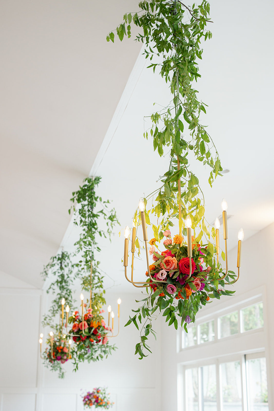 hanging floral chandelier installation with phos lighing at hutton house for summer wedding.