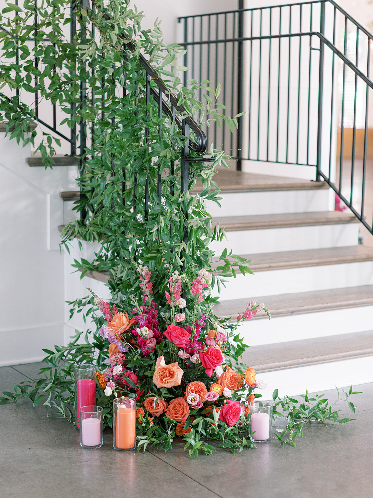 Hutton house staircase with colorful floral spray and greenery