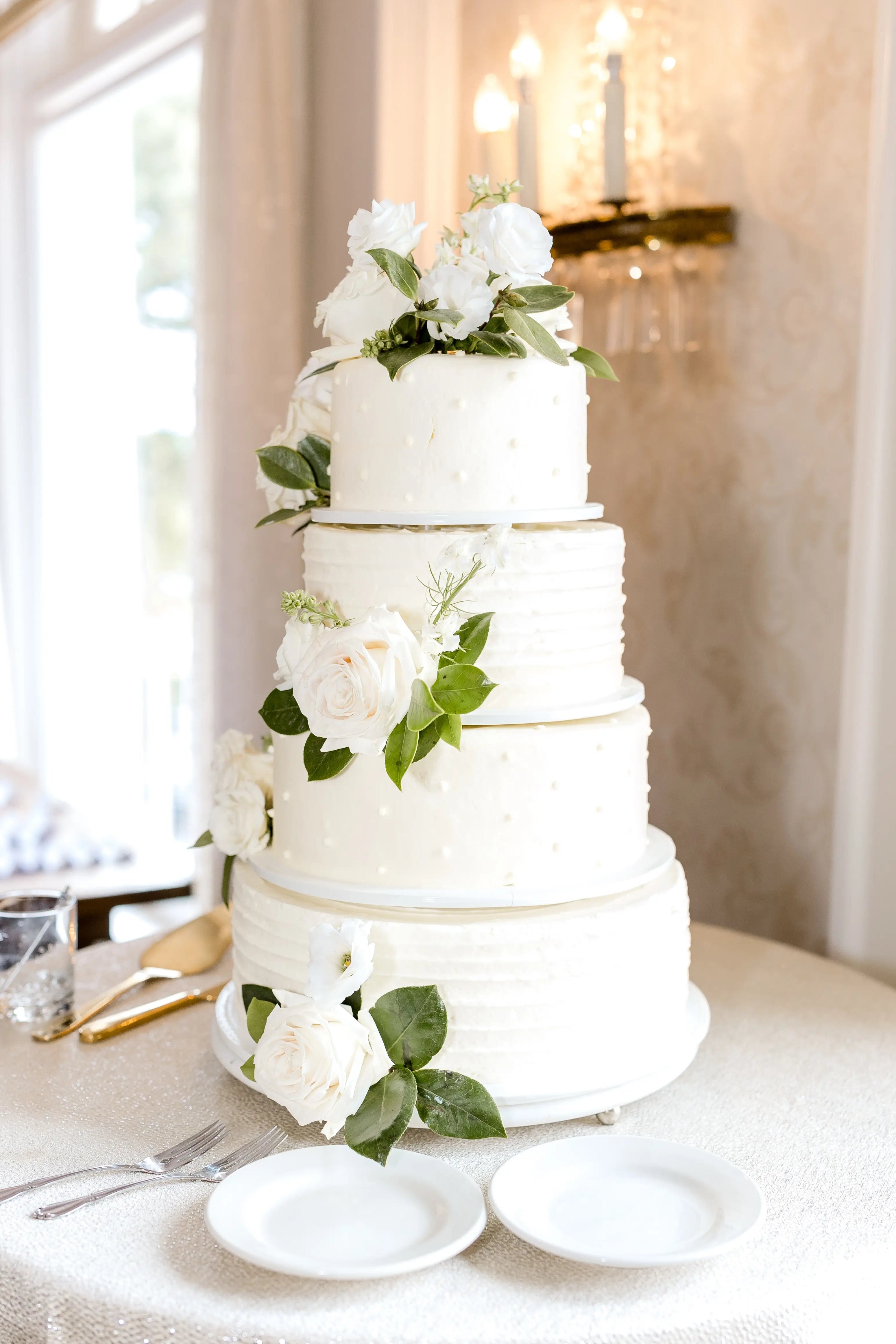 Minimal floral accents on white wedding cake from local Edina florist. 