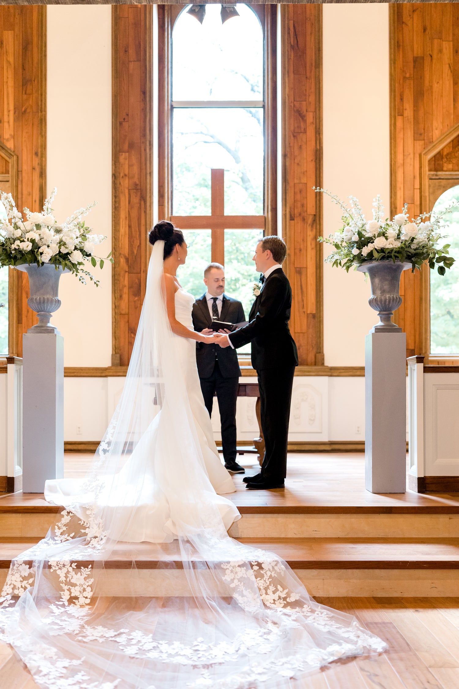 wedding ceremony flowers in gray urns on pedestals for a church ceremony in minnetonka by The Petal wedding florist