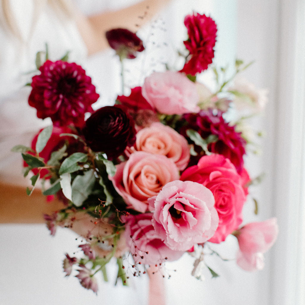Moody Bridal bouquet of dahlias, roses, lisianthus, and ranunculus for a luxury wedding celebration in Minneapolis. Order an a la carte bridal bouquet for your wedding day.