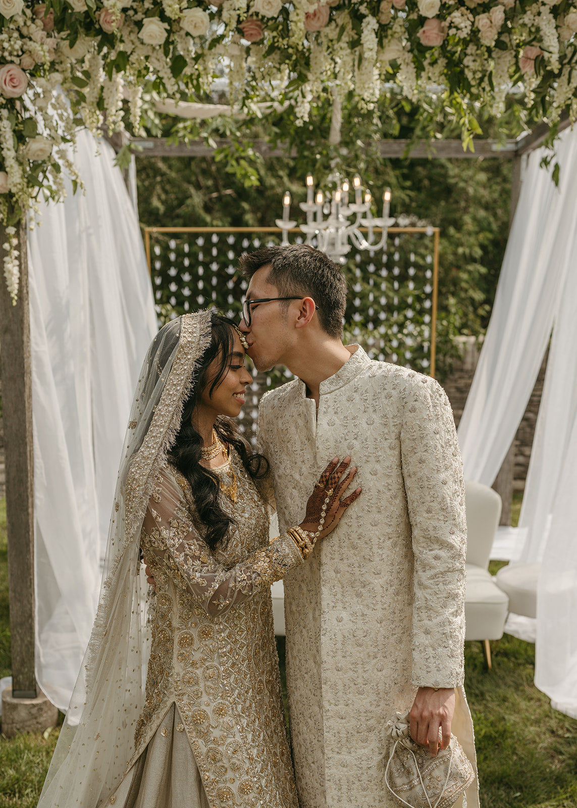 luxury muslim and chinese wedding ceremony floral arch with chandelier and soft romantic drapery by The Petal in Minneapolis