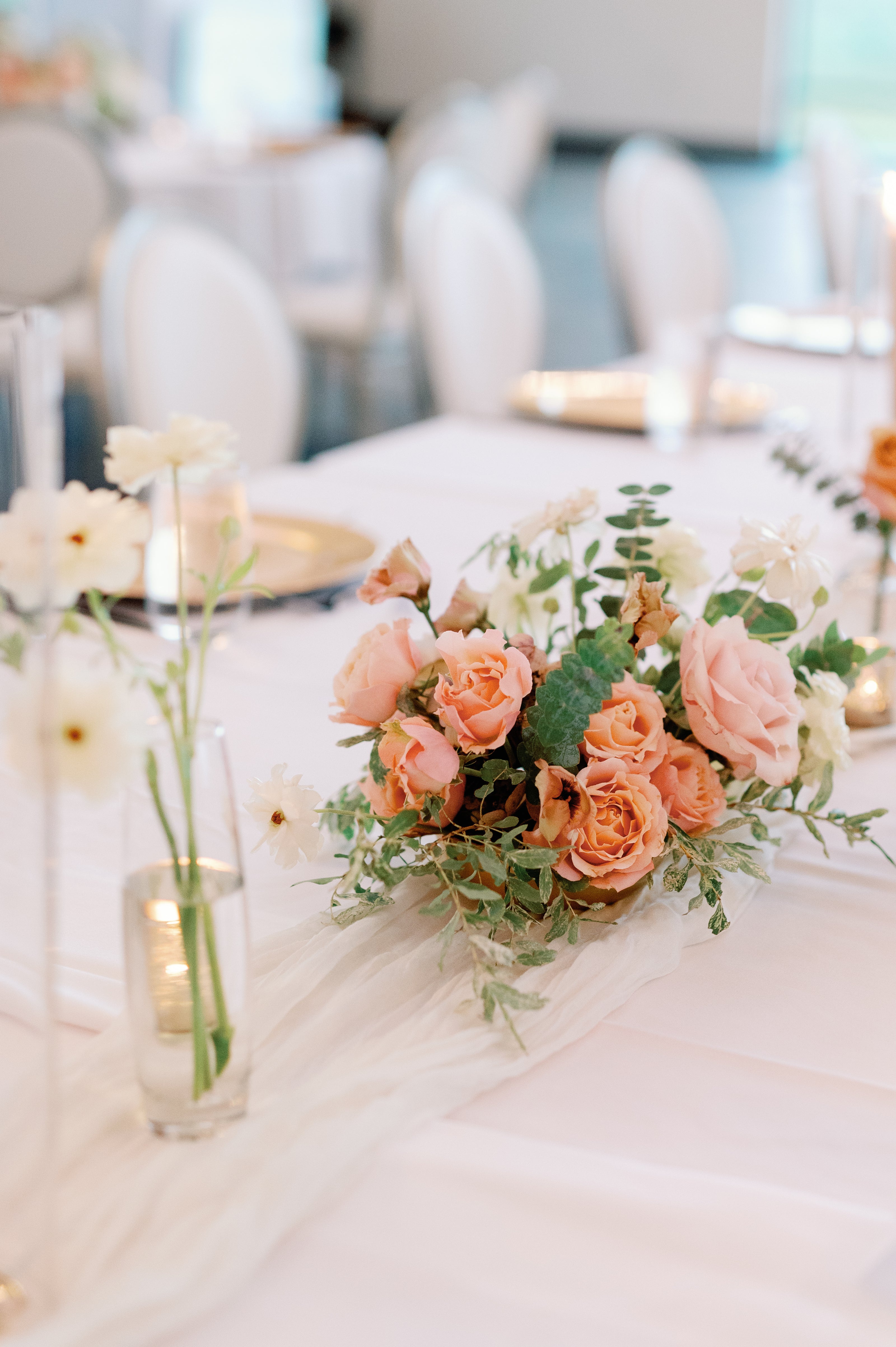 Small centerpiece of peach garden flowers for wedding in wayzata by top wedding florist the petal