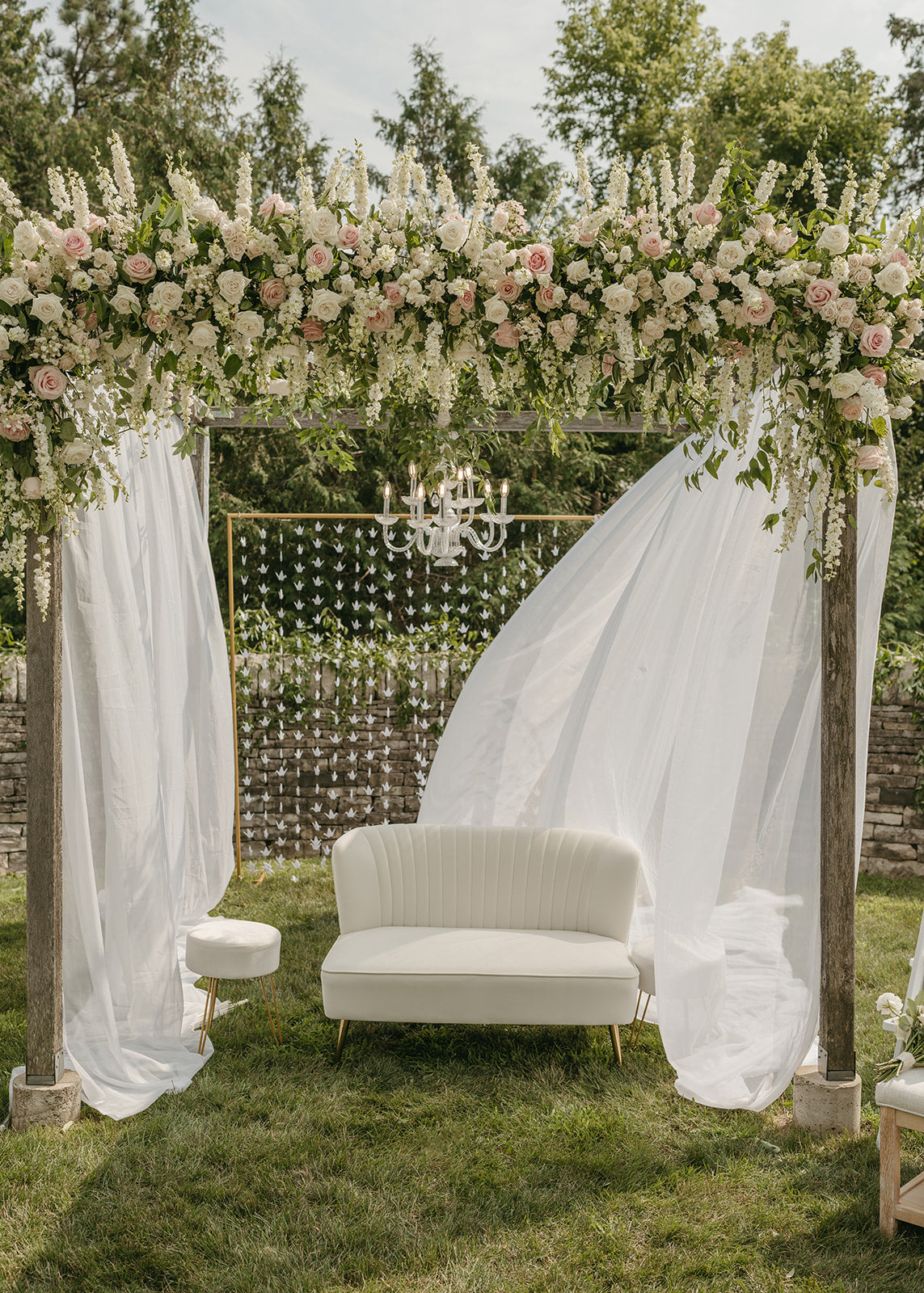 Southeast asian wedding arch with soft neutral flowers and soft drapery.  Top asian wedding florist in Minneapolis, Minnesota