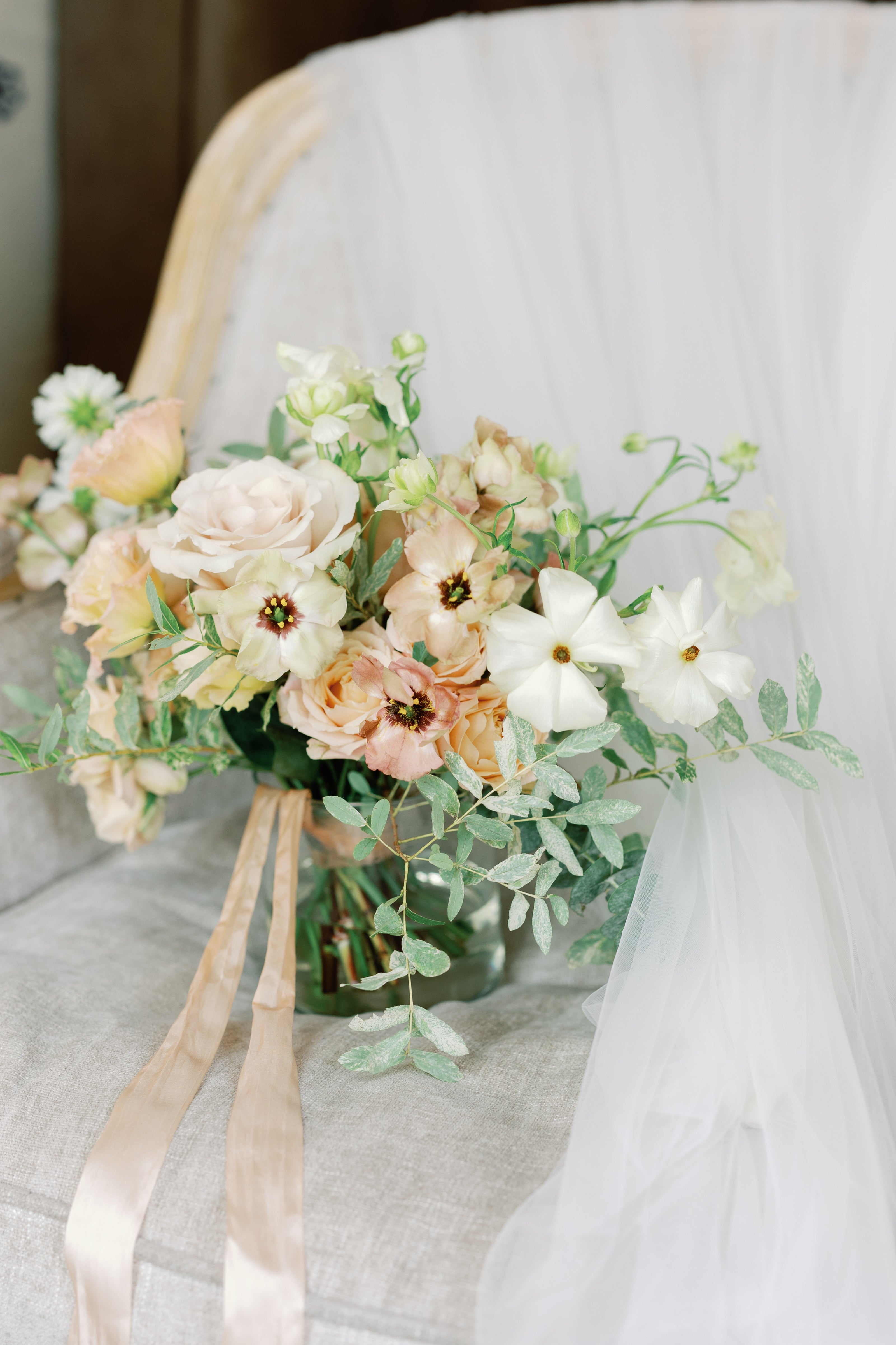 romantic bouquet of soft peach flowers by luxury wedding florist The Petal Floral Design Photographed by Marit Williams