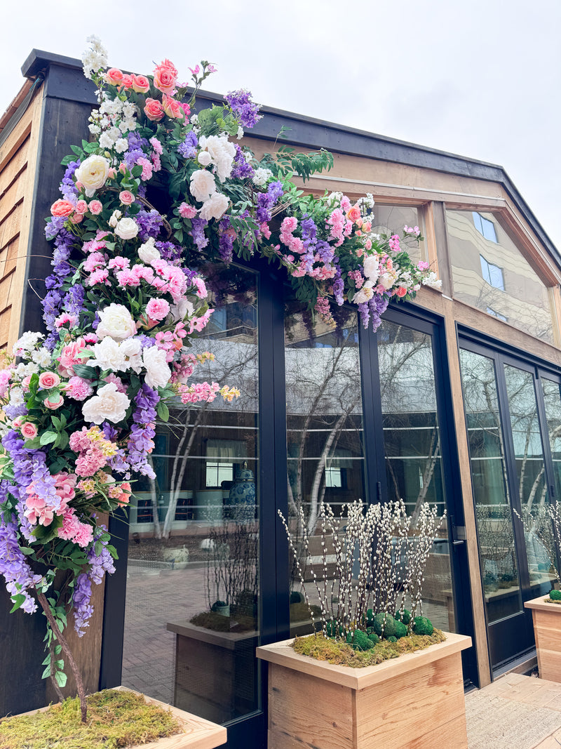 Silk permanent floral installation of beautiful flowers on business exterior. Custom designed