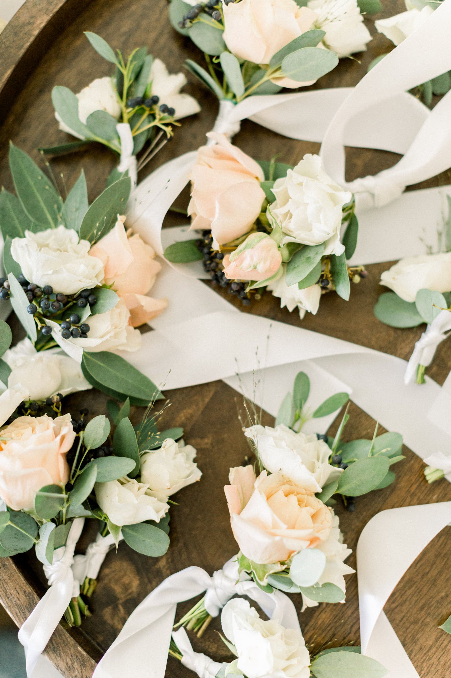 Custom wrist corsage with premium flowers tied on with a delicate ribbon. Perfect for homecoming, prom, weddings and celebrations. Soft neutrals. whites.