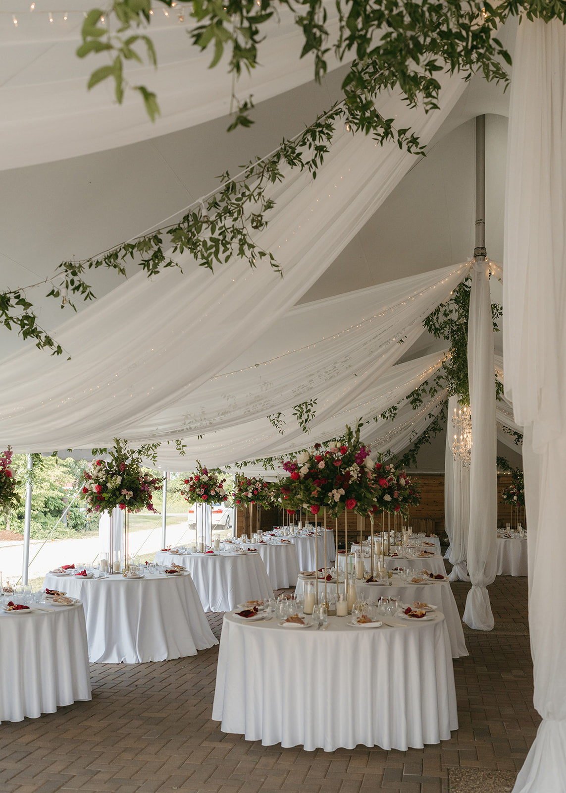 Luxury elevated garden-style wedding reception with hanging greenery for southeast asian wedding by top Minneapolis wedding florist, The Petal.