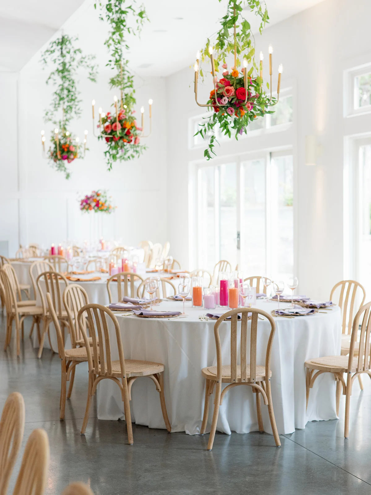 Colorful hanging installation of flowers and greenery from a chandelier at the hutton house