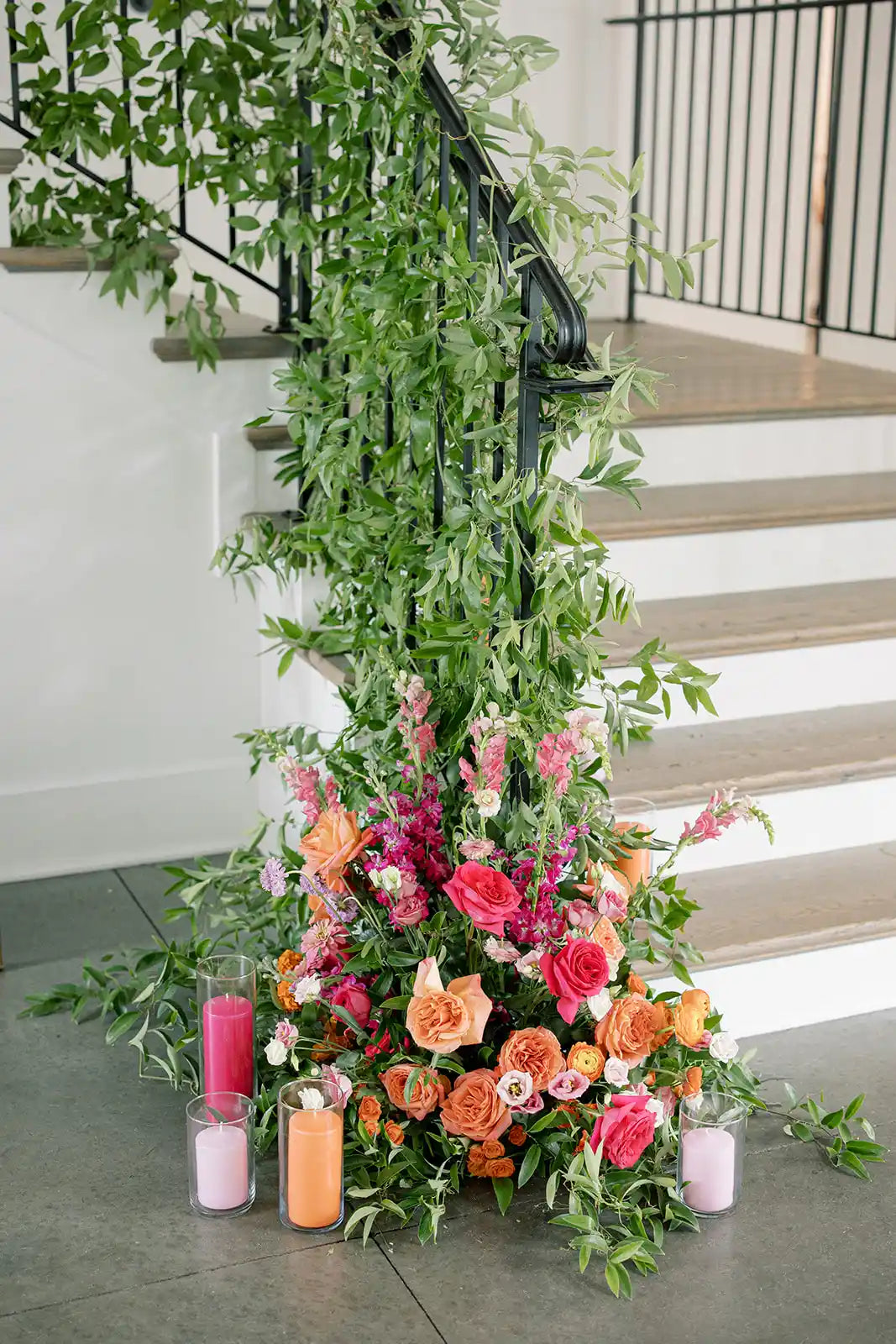 Decorative and draping floral installation at The Hutton House in Minneapolis, Minnesota with accent candles to match the exquisite blooms. 