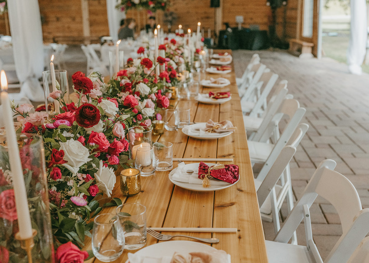 Luxury floral arrangements for a head table for a tented wedding on lake minnetonka in minnesota.