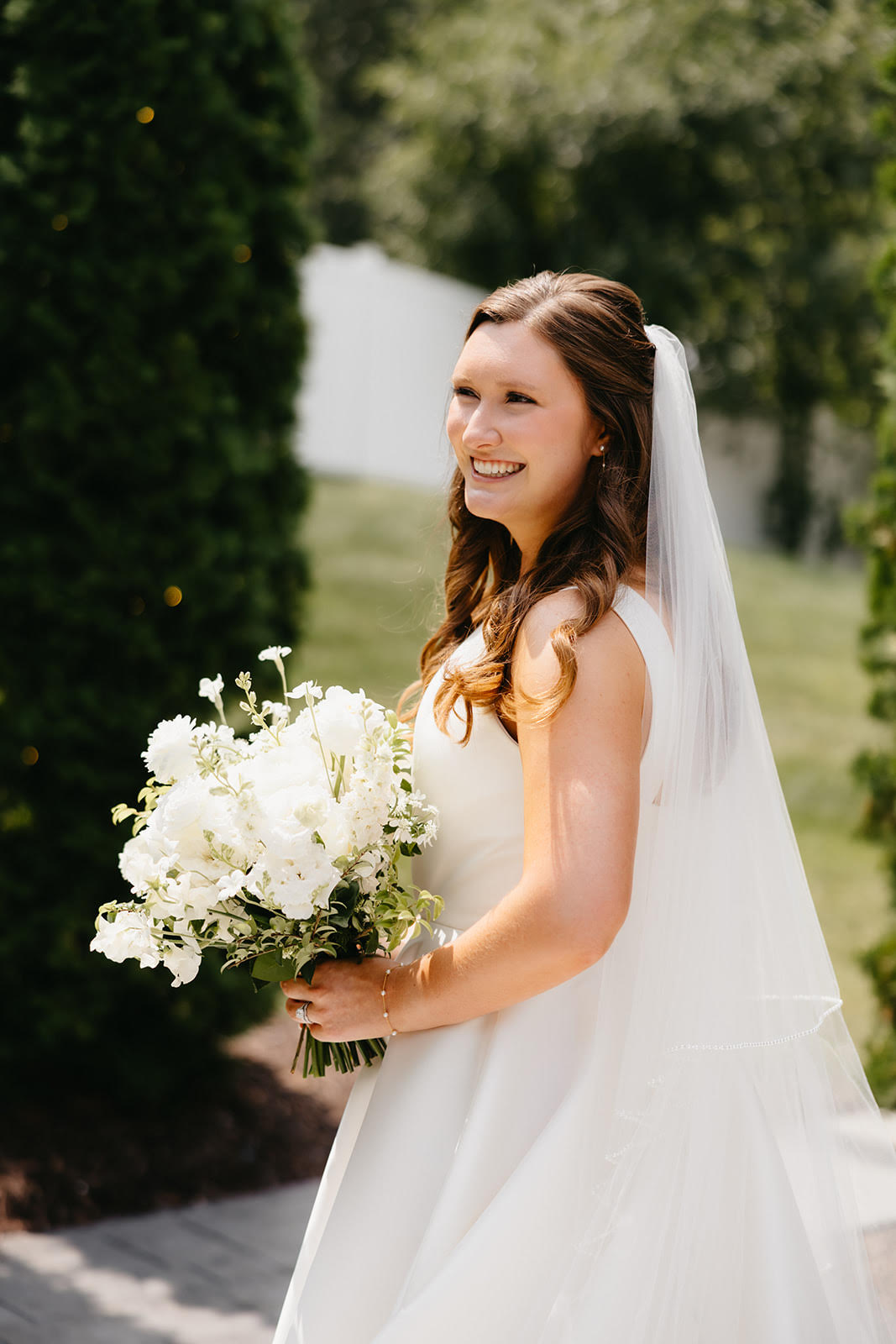 Bride holding a bouquet of white flowers outdoors for a wedding in minneapolis, minnesota