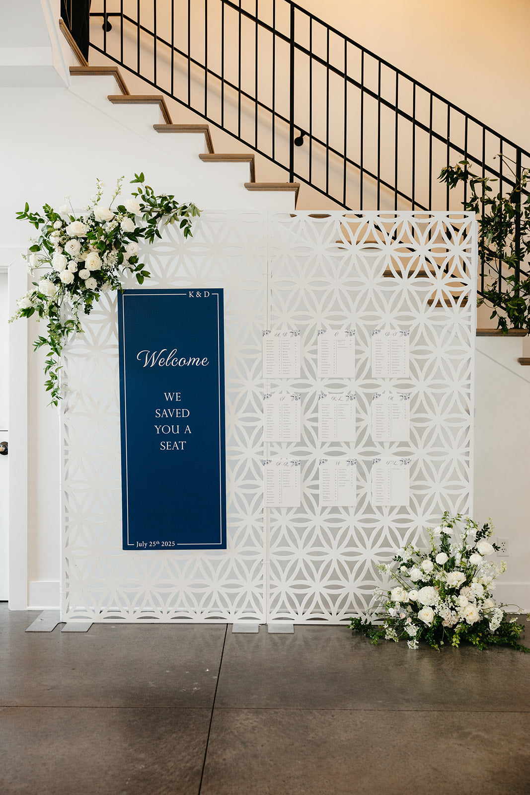 welcome sign with floral arrangements and a 'Welcome' sign in a modern interior setting for a wedding at the hutton house